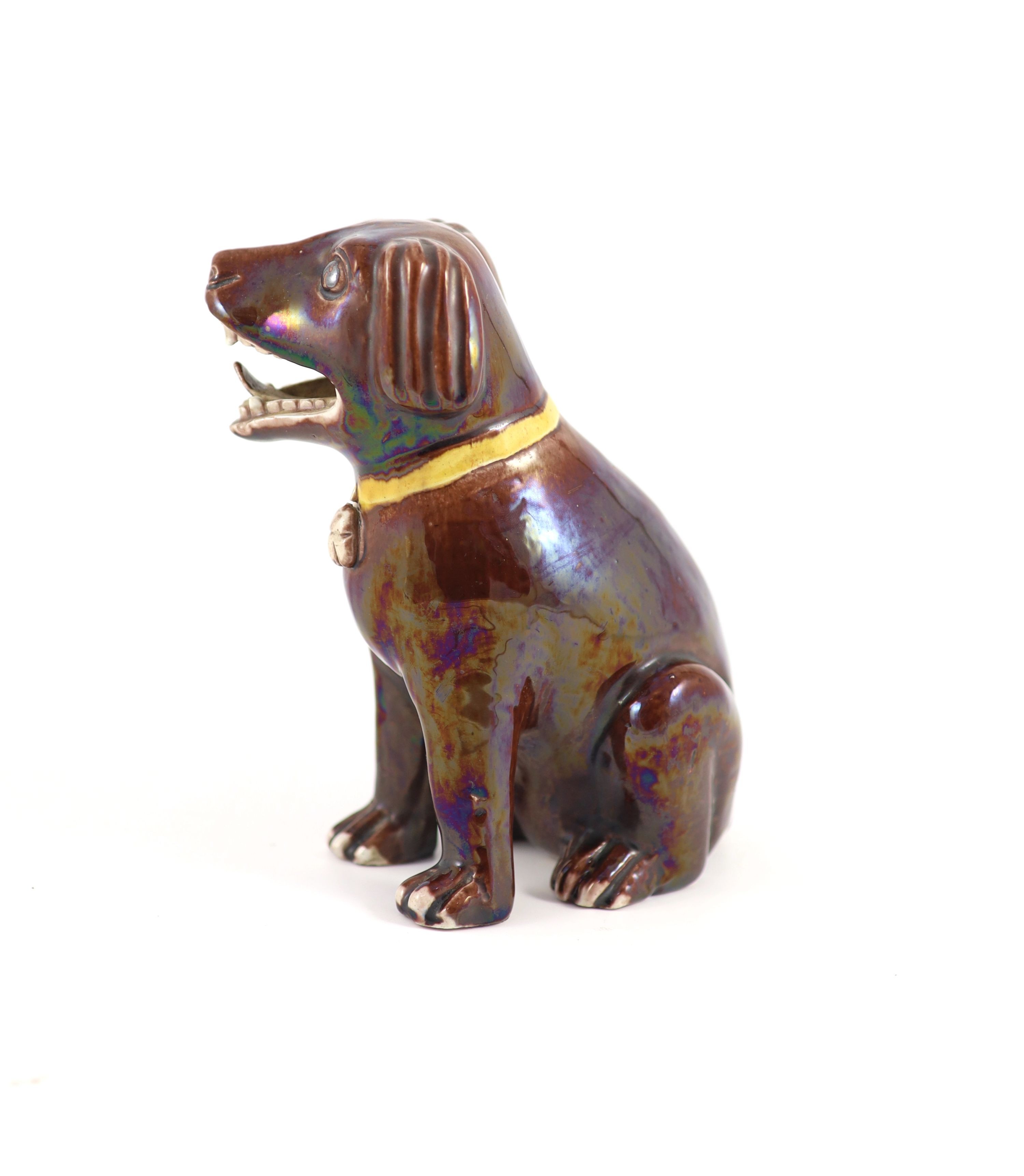 A Chinese brown glazed porcelain model of a seated dog, Qianlong period, 17.5 cm high
